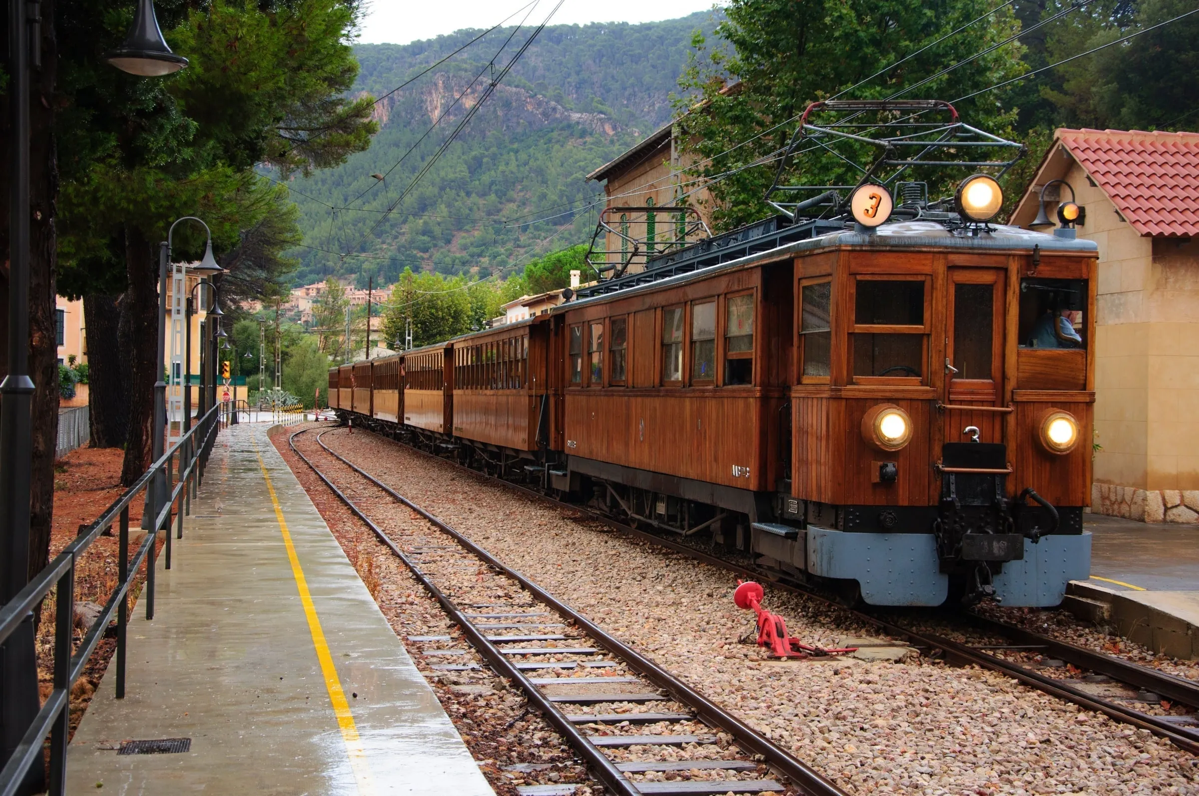 Historic Sóller train station with vintage wooden carriages